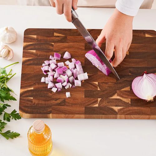 Planche à découper en bois decoupe de legume avec un couteau